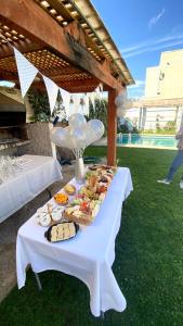 a table with a buffet of food on it at Alojamientos San Sebastián Talca in Talca