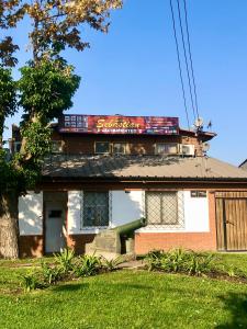 a house with a sign on the top of it at Alojamientos San Sebastián Talca in Talca