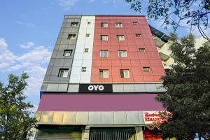 a tall red building with an ovo sign on it at Collection O Hotel Hemadri Residency in Bangalore
