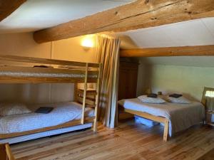 two bunk beds in a room with wooden floors at Secheras: House / Villa - Sècheras in Sécheras