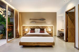 a bedroom with a large bed in a room at Villa Paso by BaliSuperHost in Ubud