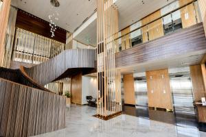 a lobby with a staircase in a building at Lovina 31-ABAC at One Residence in Batam Center