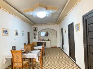 a dining room with tables and chairs and a ceiling at Gold Khiva in Khiva
