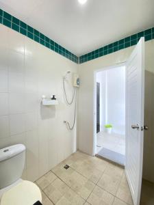 a bathroom with a shower and a toilet and a shower at Shaka Guest House in Kata Beach