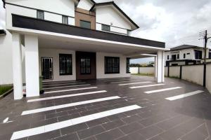 Biały dom z czarnym dachem w obiekcie JJ Homestay -Stapok w mieście Kuching
