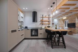 a kitchen with a wooden table and a counter top at Corfu Venetian Luxury Apartment in Corfu Town