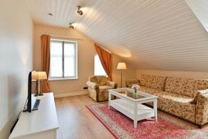 a living room with a couch and a table at Pargimaja Apartments in Kuressaare