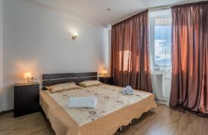 a bedroom with a large bed and a large window at 2-room Apartment Gudauri Penta 303 in Gudauri