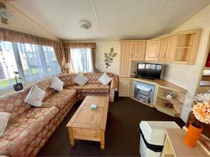 a living room with a couch and a table at The Grange - Ingoldmells - Fantasy Island in Ingoldmells