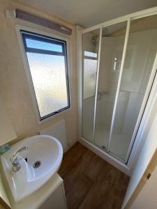 a bathroom with a white sink and a shower at The Grange - Ingoldmells - Fantasy Island in Ingoldmells