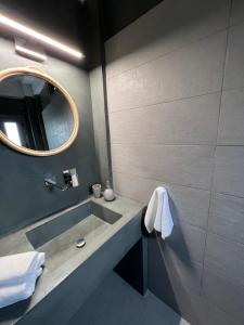 a bathroom with a sink and a mirror at Koroni Luxury Maisonette in Koroni