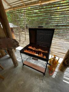a fireplace in a room with a brick wall at Watersmeet Glamping in Deraniyagala