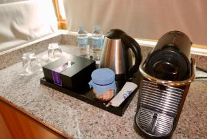 a kitchen counter with a coffee maker and a blender at Acuatico Beach Resort & Hotel Inc. in San Juan