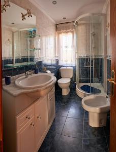 uma casa de banho com 2 lavatórios, um chuveiro e um WC. em El Mirador 2 em Paralacuesta