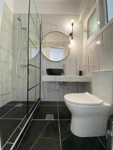 a bathroom with a toilet and a mirror at Alexander apartment 2 in Spartia