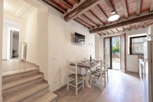 - une cuisine et une salle à manger avec une table et des chaises dans l'établissement Podere del Ciacchi Among Tuscany Greenery - Happy Rentals, à Montieri