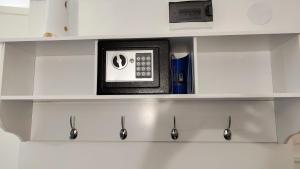 a microwave sitting on top of a shelf at Room Angel in Petrovaradin