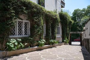 a house with ivy growing on the side of it at Casa Bouganville - St. Peter Romantic Apartment in Rome