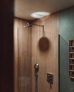 a shower stall in a bathroom with wooden walls at ANITSA RESORT in El Nido
