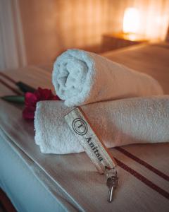a towel with a key and a flower on a bed at ANITSA RESORT in El Nido