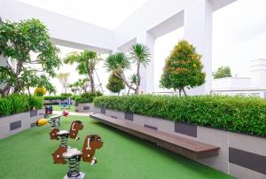 a rendering of a building with artificial grass at January Apartment in Ho Chi Minh City