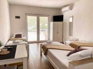 Postel nebo postele na pokoji v ubytování Studio apartmani Alex Doll