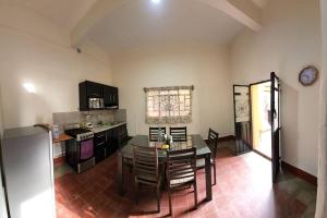 a kitchen with a table and chairs in a room at Departamento Arista in Oaxaca City