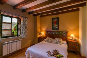 a bedroom with a bed and a window at Posada Caborredondo in Santillana del Mar