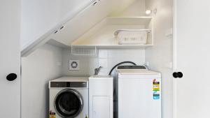 a laundry room with a washer and dryer at Bunnys in Mount Hotham