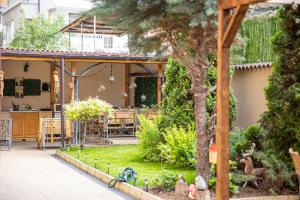 a garden with a house with a table and chairs at Villa Martina in Nesebar