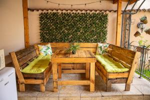 a wooden table and chairs on a patio at Villa Martina in Nesebar