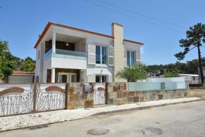 a house with a gate in front of it at Hide&Sea Aroeira villa w/ heated pool at the Beach in Aroeira