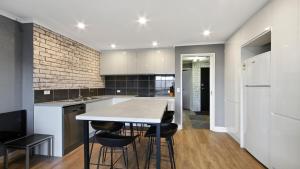 a kitchen with a table and some chairs in it at Lawlers 29 in Mount Hotham +4 photos