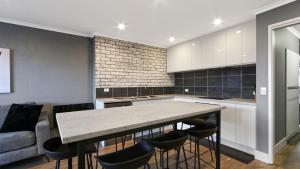 a kitchen with a large table and some chairs at Lawlers 29 in Mount Hotham