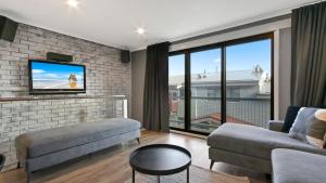 a living room with a couch and a tv at Lawlers 29 in Mount Hotham