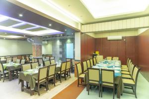 Hotel Golden Inn Chattagram Ltd في شيتاغونغ: غرفة طعام مع طاولات وكراسي في غرفة