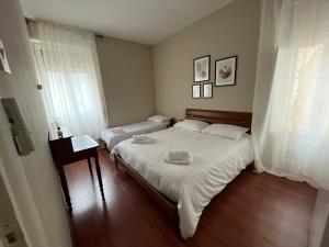 a small bedroom with two beds and a window at Esme House in Foggia