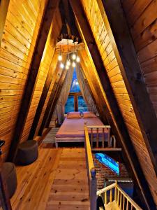 a bedroom in a attic with a bed in it at Life on the farm in Nepravishtë