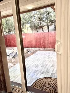 a sliding glass door with a view of a yard at Rustic Retreat Cottage in Payson