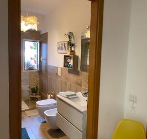 a bathroom with a white toilet and a sink at Gallery 123 Luxury Room in Agrigento +8 photos