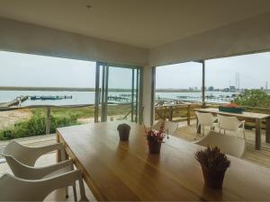 a dining room with a table and views of the ocean at Velddrif River and Sea in Velddrif