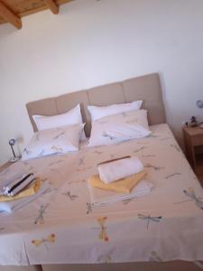 a bed with towels and pillows on it at Holiday Home Zule in Žrnovo