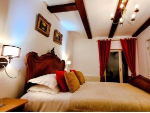 a bedroom with a large bed with red curtains at Carpathia Magic in Peştera