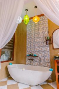 a bathroom with a white bath tub in a room at Boutique Villa in Hoi An Oldtown in Hoi An