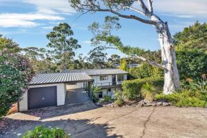 a home in the bush with a tree at Fields of Green by Experience Jervis Bay in Vincentia