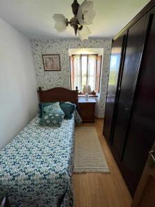 a bedroom with a bed and a ceiling fan at Casa Rural La Pereda in Noriega