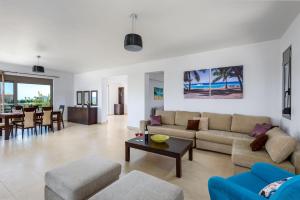 a living room with a couch and a table at Villa Anolia with Private Pool in Koskinou +24 photos