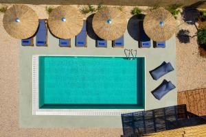an overhead view of a swimming pool with umbrellas at Villa Anolia with Private Pool in Koskinou