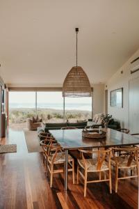 a living room with a large table and chairs at Hearns Beachside Villa 9 in Port Fairy
