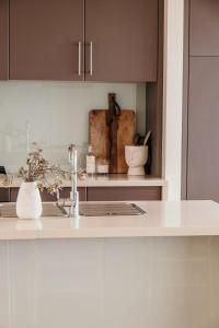 a kitchen with a sink and a counter top at Hearns Beachside Villa 9 in Port Fairy